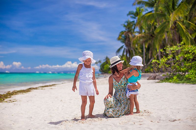 family on white beach in boracay