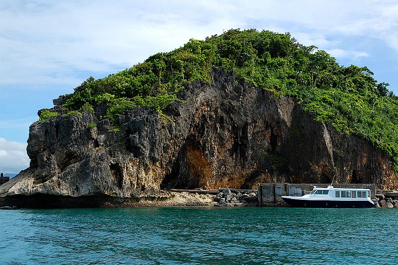 Rock formation and boat at Boracay island in Aklan, Philippines.